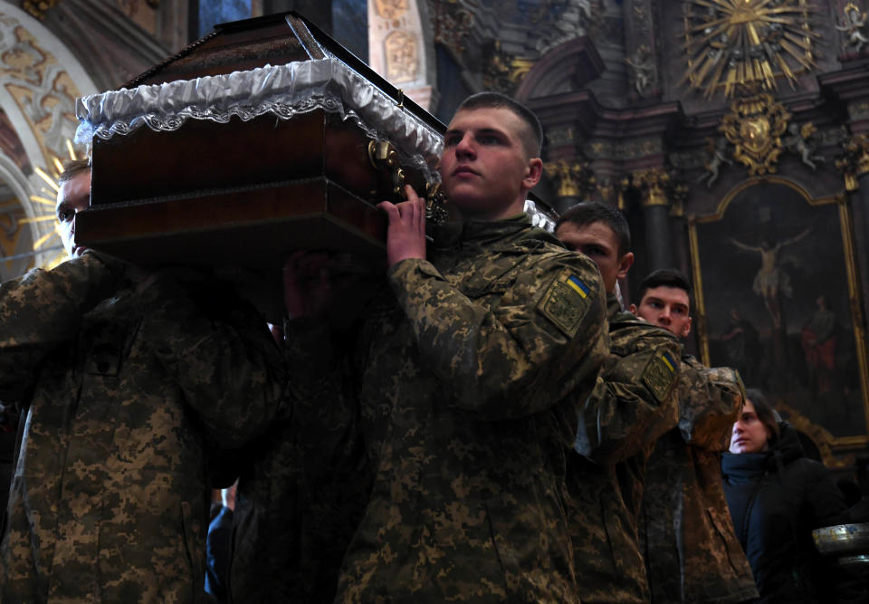 Soldiers carrying a casket during the funeral service.