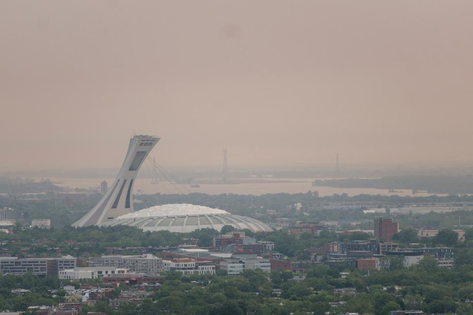 The Olympic Stadium as Montreal is shrouded in smog on June 6, 2023, in Montreal, Canada. Environment Canada issued a smog advisory for the second day in a row. Particles in the air from forest fires in the north of Quebec are impacting parts of Southern Quebec and Ontario. (Photo by ANDREJ IVANOV / AFP) (Photo by ANDREJ IVANOV/AFP via Getty Images)