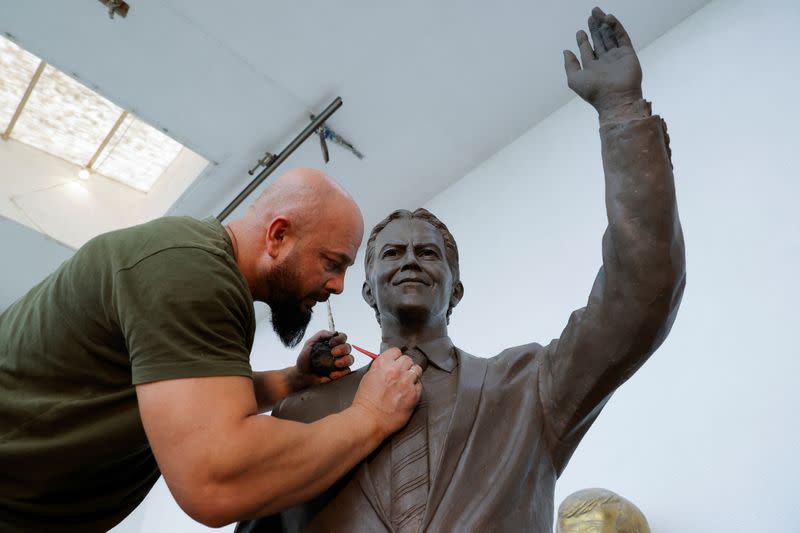 Sculptor Agon Qosa works on a statue of Britain's former prime minister Tony Blair, in Ferizaj