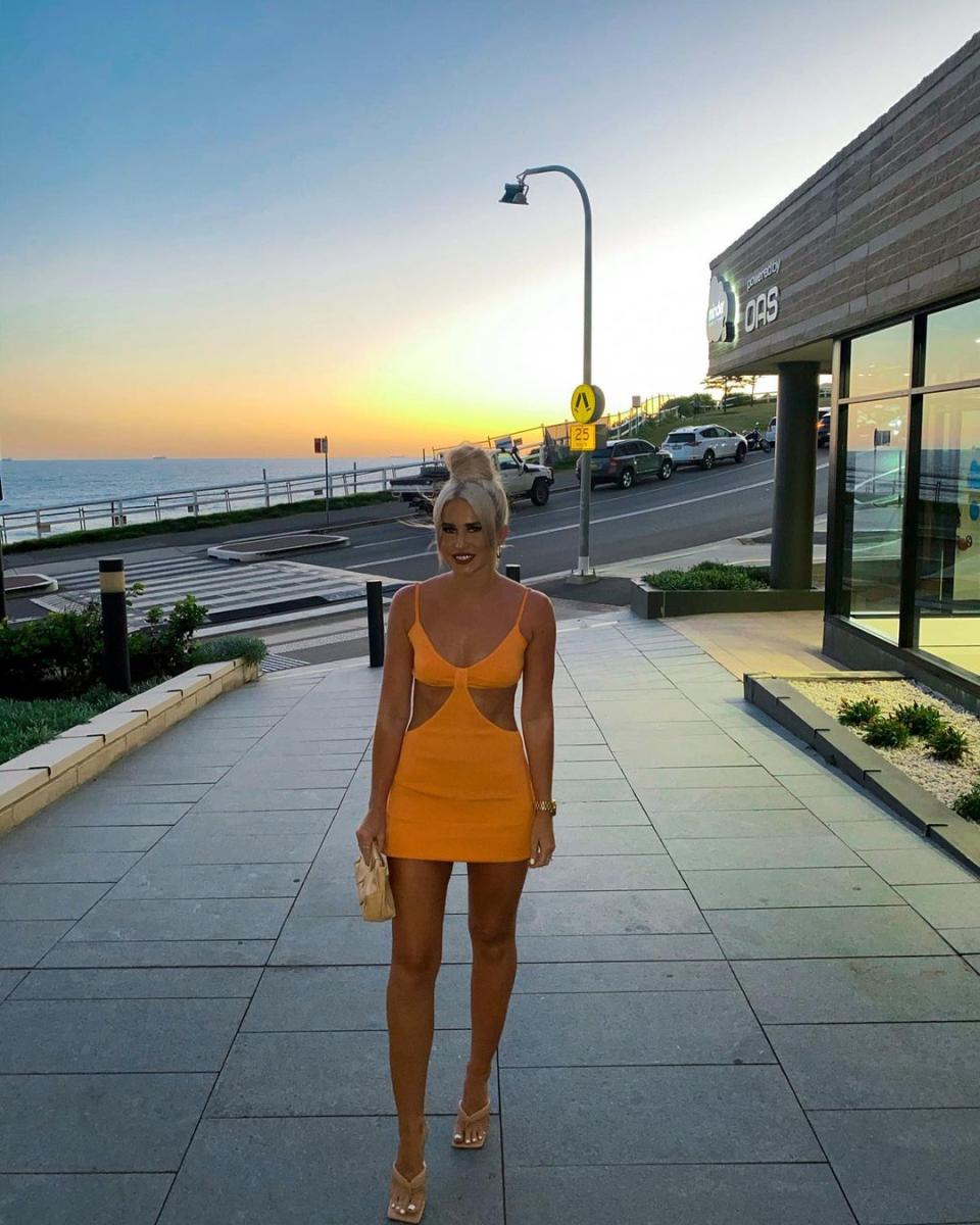 Woman in orange cut out dress