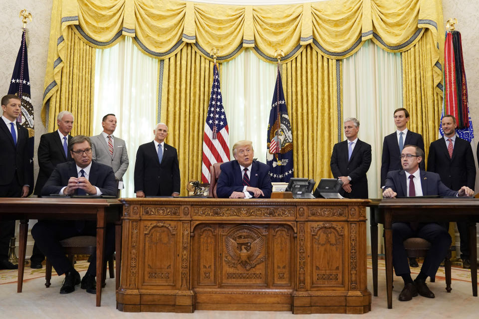 President Donald Trump speaks after participating in a signing ceremony with Serbian President Aleksandar Vucic, seated left, and Kosovar Prime Minister Avdullah Hoti, seated right, in the Oval Office of the White House, Friday, Sept. 4, 2020, in Washington. (AP Photo/Evan Vucci)