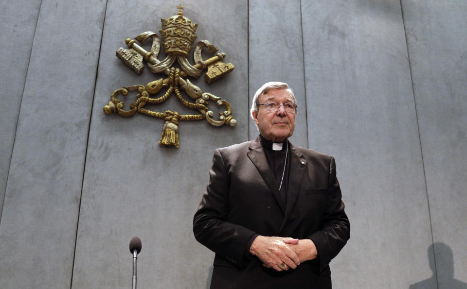 FILE - In this Thursday, June 29, 2017 file photo, Cardinal George Pell arrives to make a statement, at the Vatican, Thursday, June 29, 2017. Cardinal George Pell, the former Vatican finance minister who was convicted and then absolved of sexual abuse in his native Australia, is set to publish his prison diary musing on life in solitary confinement, the Psalms, the church, politics and sports. Catholic publisher Ignatius Press told The Associated Press on Saturday the first installment of the 1,000-page diary would likely be published in Spring 2021. (AP Photo/Gregorio Borgia, File)