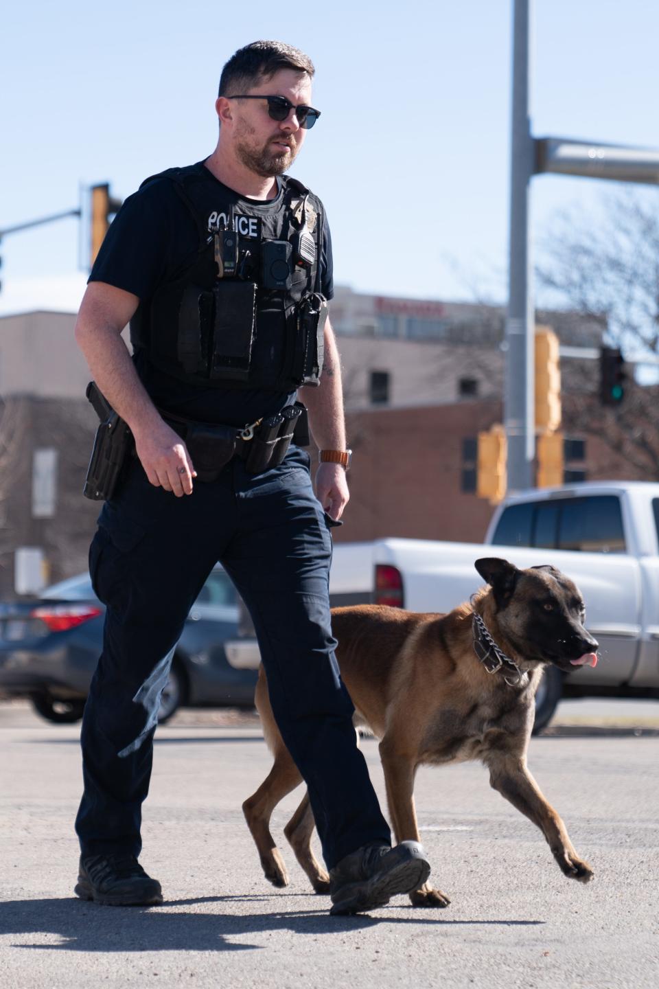 Topeka Police Department officer Devin Viergever works on heeling excersises with his three-year-old Belgium malinois Petey outside of the Law Enforcement Center. Gov. Laura Kelly vetoed a bill that would increase penalties for injuring or killing a police dog.