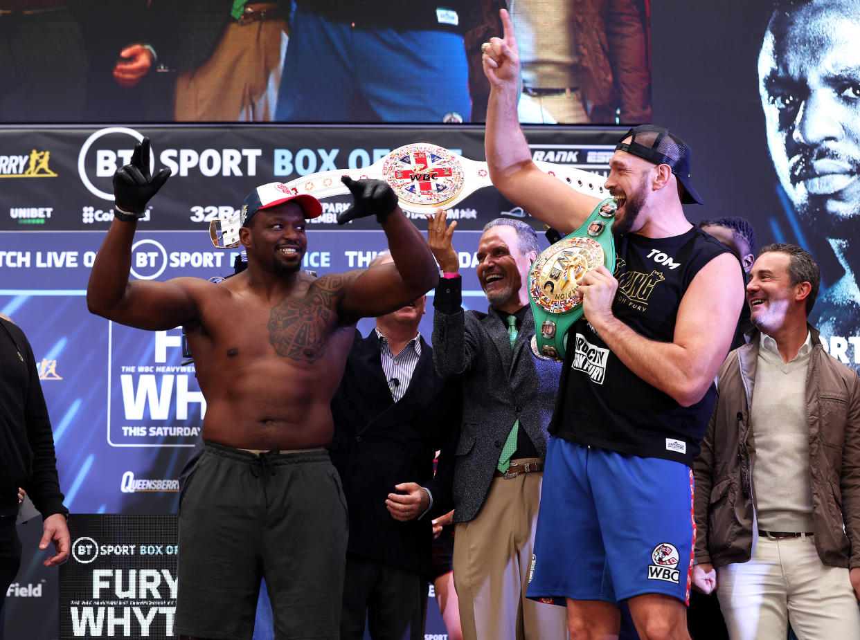 LONDON, ENGLAND - APRIL 22:   Tyson Fury of Great Britain dances on stage with Dillian Whyte of Great Britain as they face-off during the weigh-in ahead of the heavyweight boxing match between Tyson Fury and Dillian Whyte at BOXPARK on April 22, 2022 in London, England. (Photo by Julian Finney/Getty Images)