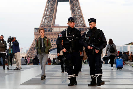 Police patrol at the Trocadero near the Eiffel Tower after a policeman was killed and two others were wounded in a shooting incident in Paris, France, April 21, 2017. REUTERS/Charles Platiau