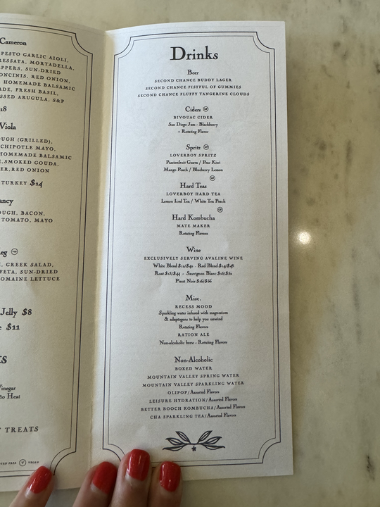 Menu featuring a variety of drinks including beer, cider, non-alcoholic options, and house-made kombucha, with several selections listed for each category