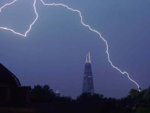 Lightning lights up the sky over The Shard in central London on Saturday - Credit: @samueltwilkinson/PA