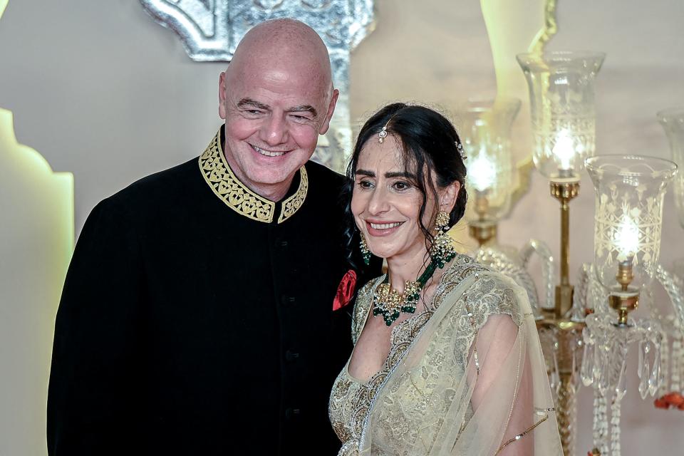 FIFA President Gianni Infantino and his wife Leena Al Ashqar smile for the photographers.