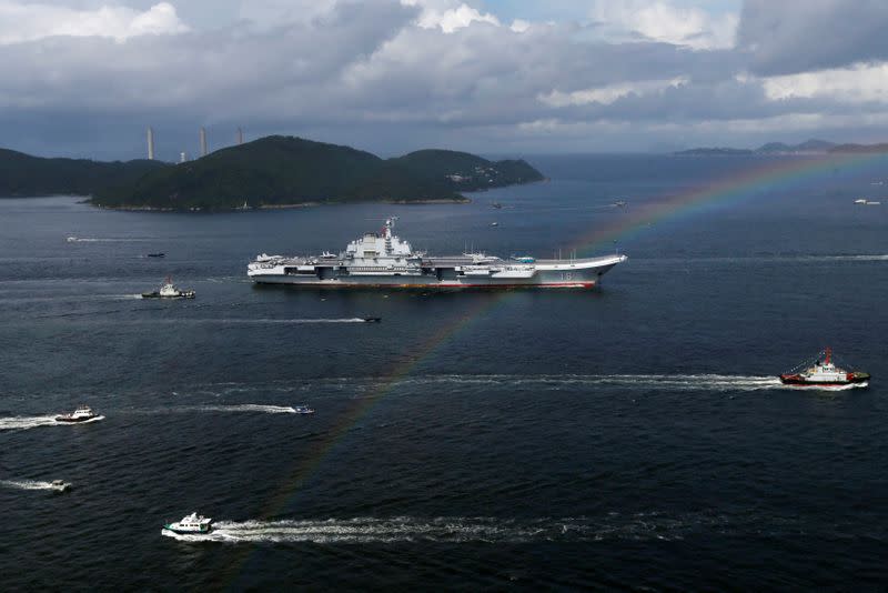 FILE PHOTO: China's aircraft carrier Liaoning sails past a rainbow as it enters Hong Kong