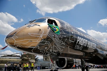 FILE PHOTO: An Embraer E195-2 is seen on display, sporting a livery combining a lion's head with an integrated circuit design, during the 53rd International Paris Air Show at Le Bourget Airport near Paris