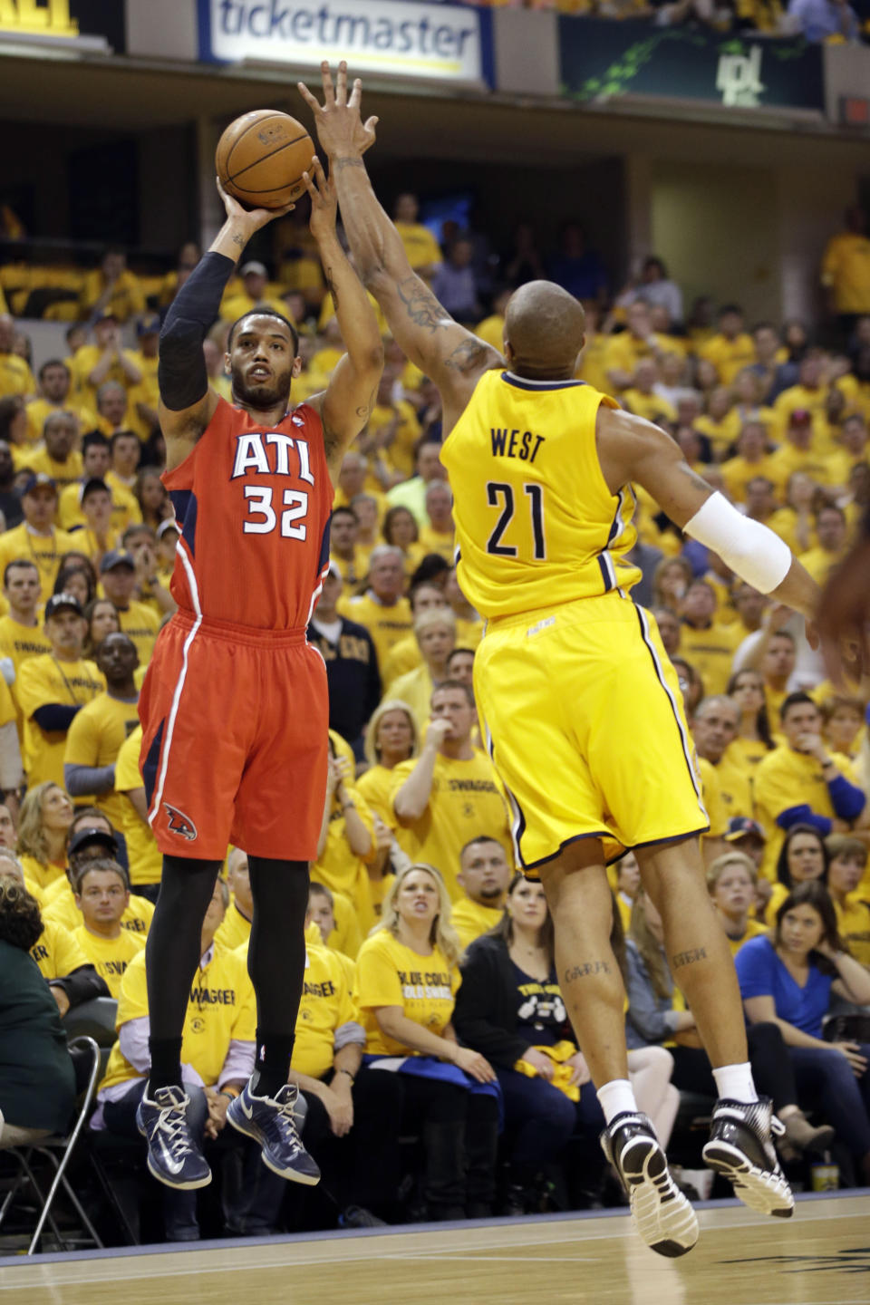 Atlanta Hawks forward Mike Scott (32) shoots over Indiana Pacers forward David West (21) during the first half of Game 7 of a first-round NBA basketball playoff series in Indianapolis, Saturday, May 3, 2014. (AP Photo/AJ Mast)