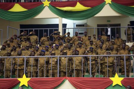 Soldiers salute during the swearing-in ceremony of Burkina Faso's President Michel Kafondo in Ouagadougou November 21, 2014. REUTERS/Joe Penney