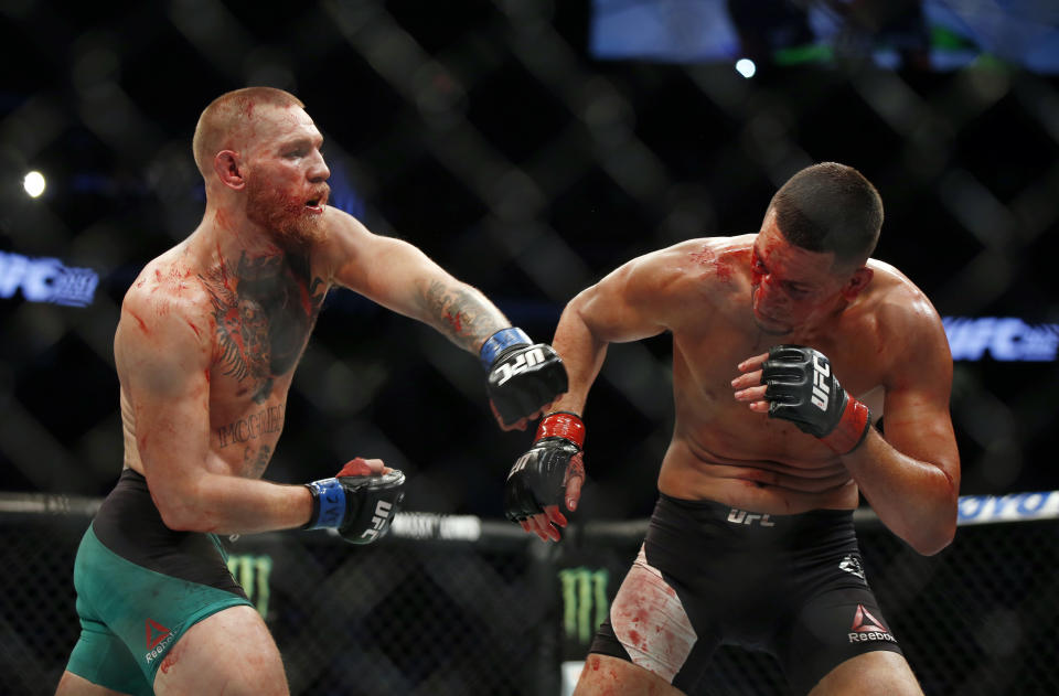 Conor McGregor fights Nate Diaz during their welterweight mixed martial arts bout at UFC 202 on Saturday, Aug. 20, 2016, in Las Vegas. McGregor won by split decision. (AP Photo/Isaac Brekken)