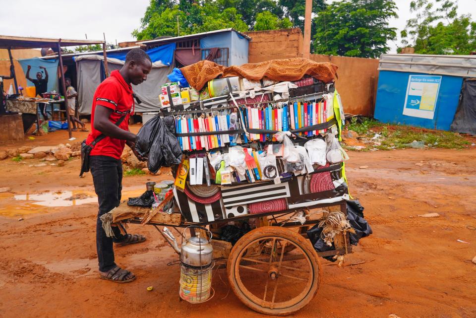 A street merchant waits for customers in Niamey, Niger, Monday, Aug. 14, 2023. Niger's mutinous soldiers say they will prosecute deposed President Mohamed Bazoum for "high treason" and undermining state security.