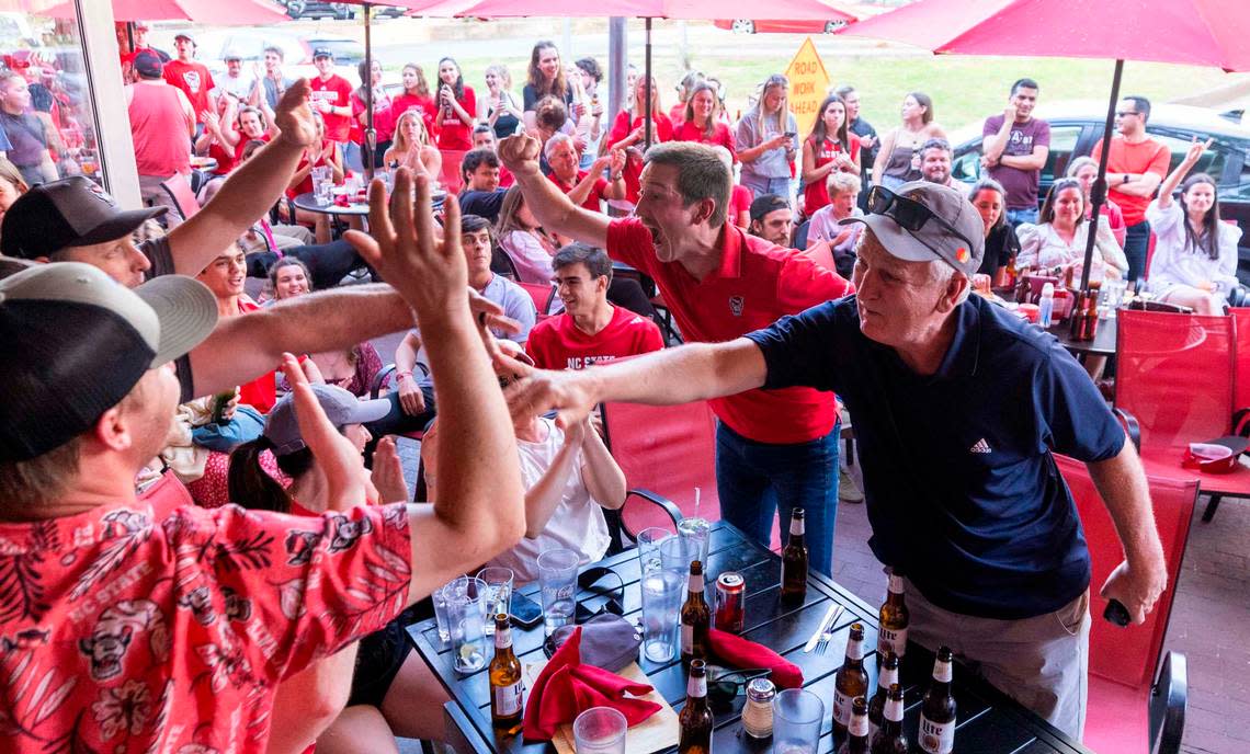 NC state fans at Players’ Retreat in Raleigh celebrate a Wolfpack lead against Duke during the second half of the Elite Eight round of the NCAA Men’s Division I Basketball Tournament on Sunday, March 31, 2024.