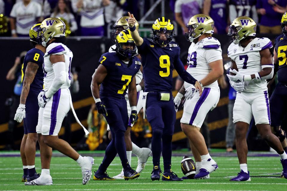 Michigan quarterback J.J. McCarthy celebrates after a first down during the third quarter against Washington in the College Football Playoff national championship game at NRG Stadium.