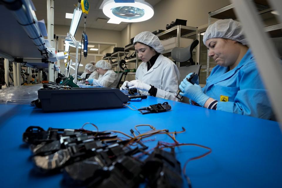 Ukrainian women assemble military drones at the drone manufacturer Atlas Aerospace in the capital Riga, Latvia, Wednesday, Feb. 1, 2023. Since Russia invaded Ukraine last February, Lithuania, Latvia and Estonia — three states on NATO’s eastern flank scarred by decades of Soviet-era occupation — have been among the top donors to Kyiv.