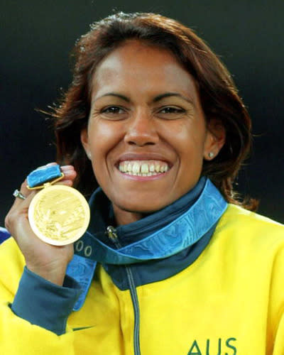 <p>Freeman smiles with her gold medal.</p>