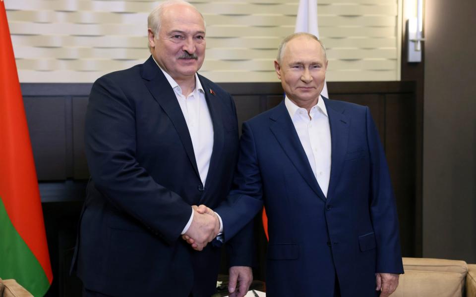 Vladimir Putin and Belarusian President Alexander Lukashenko shake hands during their meeting in Sochi, Russia
