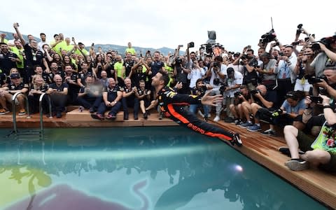 Red Bull Racing's Australian driver Daniel Ricciardo (C) jumps into a pool as he celebrates after winning the Monaco Formula 1 Grand Prix at the Monaco street circuit on May 27, 2018 in Monaco - Credit: AFP