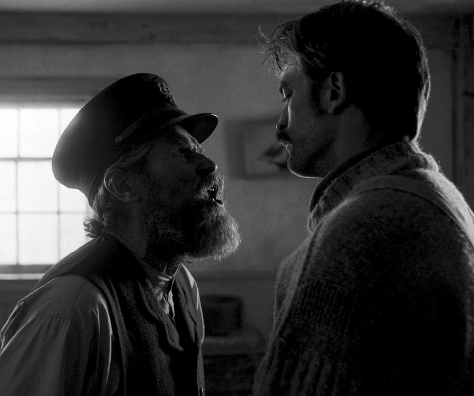 This image released by A24 Films shows Willem Dafoe, left, and Robert Pattinson in a scene from "The Lighthouse." (A24 Pictures via AP)