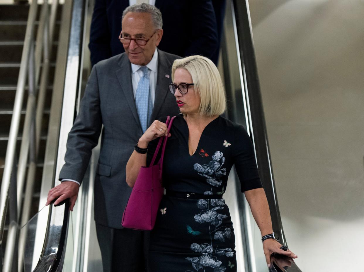 chuck schumer kyrsten sinema on an escalator together