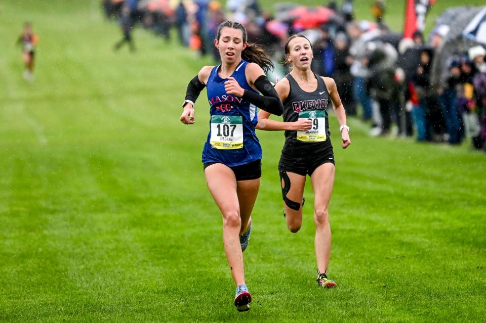 Mason's Meghan Ford, left, finishes in second place with Okemos' Shannon Gillahan coming in at third place, right, during the Greater Lansing Cross Country Championships on Saturday, Oct. 14, 2023, at Ledge Meadows Golf Course in Grand Ledge.