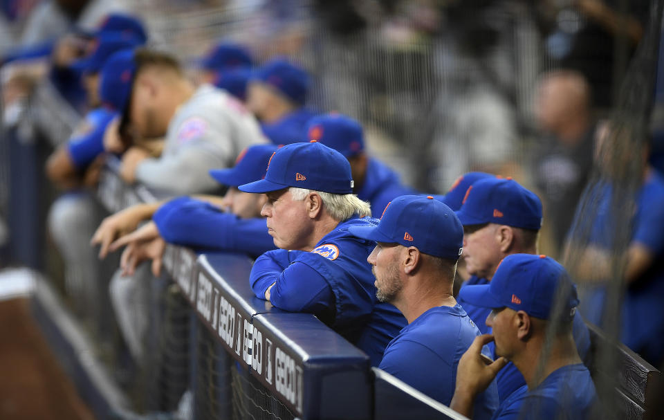 New York Mets manager Buck Showalter, center, watches his team play against the Miami Marlins during the second inning of a baseball game, Friday, March 31, 2023, in Miami. (AP Photo/Michael Laughlin)