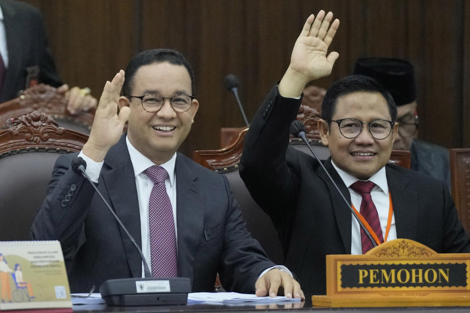 Losing presidential candidate Anies Baswedan, left, and his running mate Muhaimin Iskandar wave at the media prior to the start of the first hearing of their legal challenge to the Feb. 14 presidential election alleging widespread fraud, at the Constitutional Court in Jakarta, Indonesia, Wednesday, March 27, 2024. Defense Minister Prabowo Subianto, who chose the son of the popular outgoing President Joko Widodo as his running mate, won the election by 58.6% of the votes, according to final results released by the Election Commission. (AP Photo/Dita Alangkara)