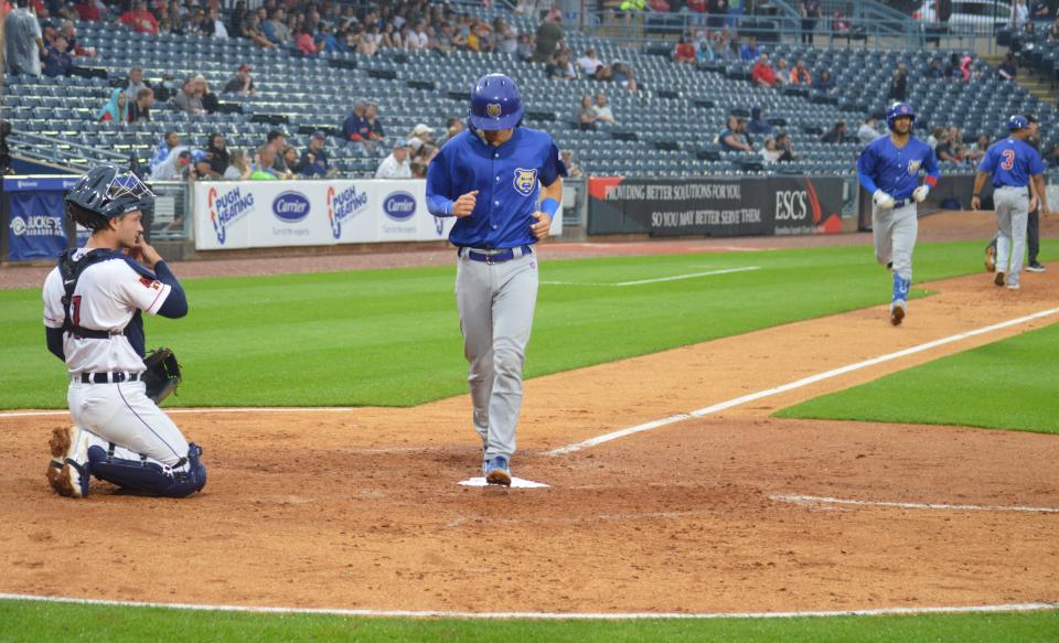 St. Mary Catholic Central graduate Bryce Windham scores a run for the Iowa Cubs in a game against the Toledo Mud Hens at Fifth Third Field Tuesday night.