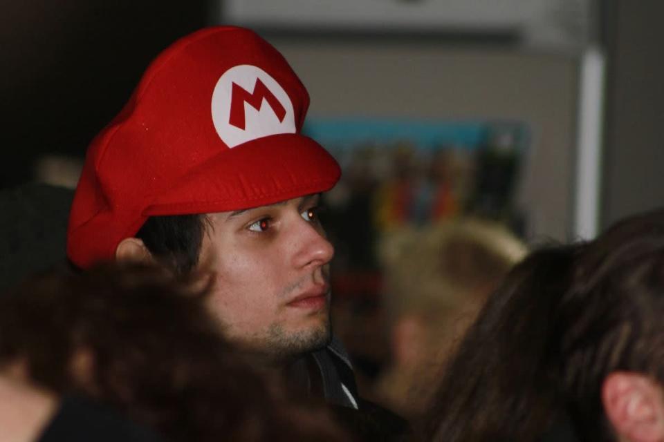 A fan of Mario waits in line to buy the console