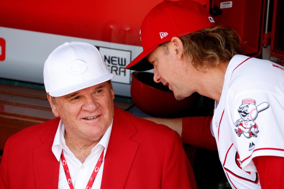 Cincinnati Reds hall of famer Pete Rose talks with Cincinnati Reds starting pitcher Bronson Arroyo (61) in the dugout before a pregame ceremony for the unveiling of Pete Rose's bronze statue being installed outside the stadium before the MLB National League game between the Cincinnati Reds and the Los Angeles Dodgers at Great American Ball Park in downtown Cincinnati on Saturday, June 17, 2017. 
