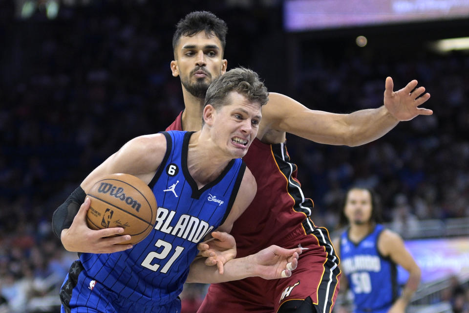 Orlando Magic center Moritz Wagner (21) drives to the basket while defended by Miami Heat center Omer Yurtseven during the first half of an NBA basketball game, Saturday, March 11, 2023, in Orlando, Fla. (AP Photo/Phelan M. Ebenhack)
