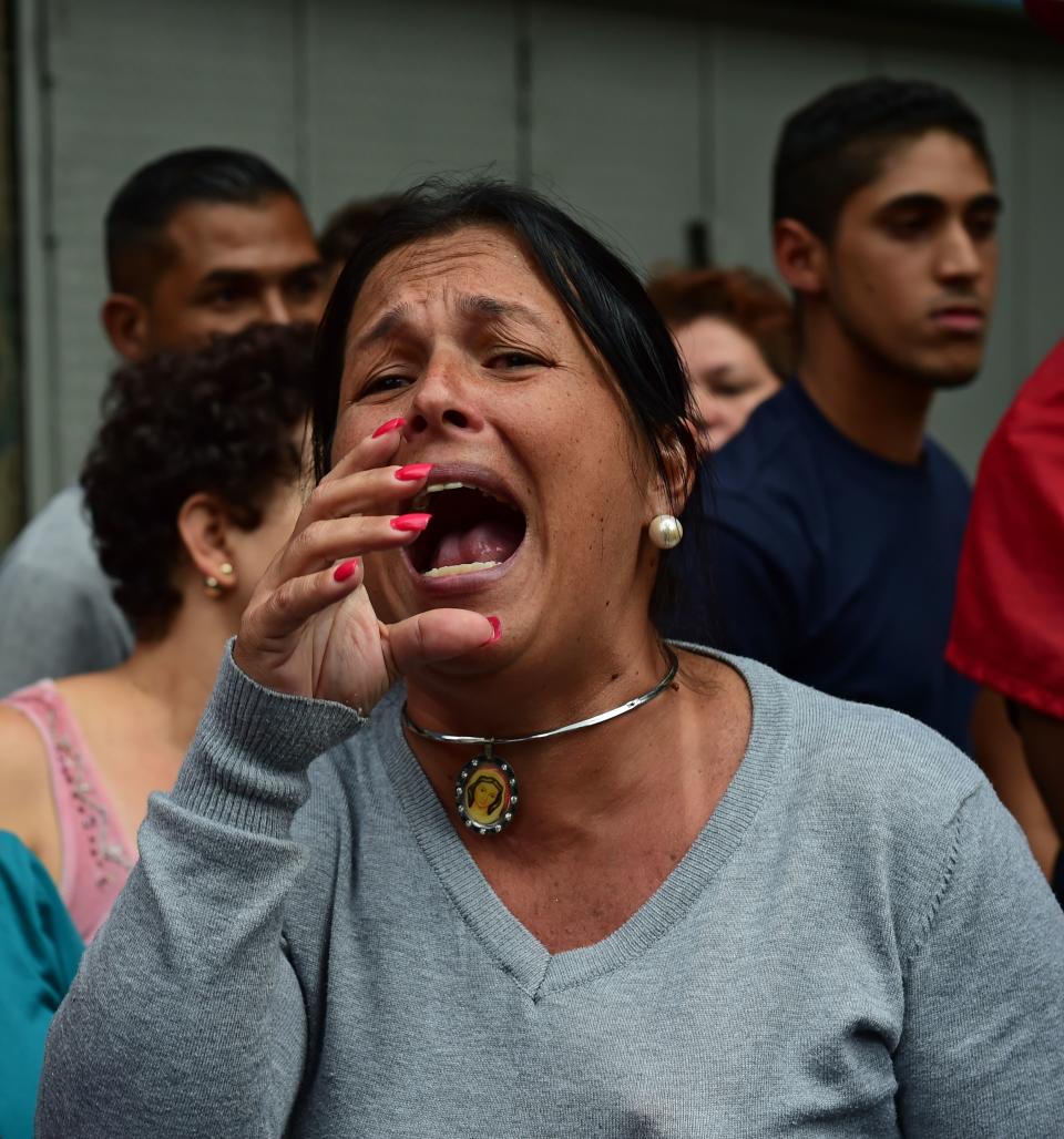 People protest against the severe food and medicine shortages near Miraflores presidential palace in Caracas on June 2, 2016. Venezuelans face long lines at supermarkets tightly guarded by nervous soldiers, bare shelves and soaring prices inside, a dysfunctional health care system short on basic medications and supplies, daily power cuts of four hours across most of the country, and a government that only operates two days a week to save electricity.