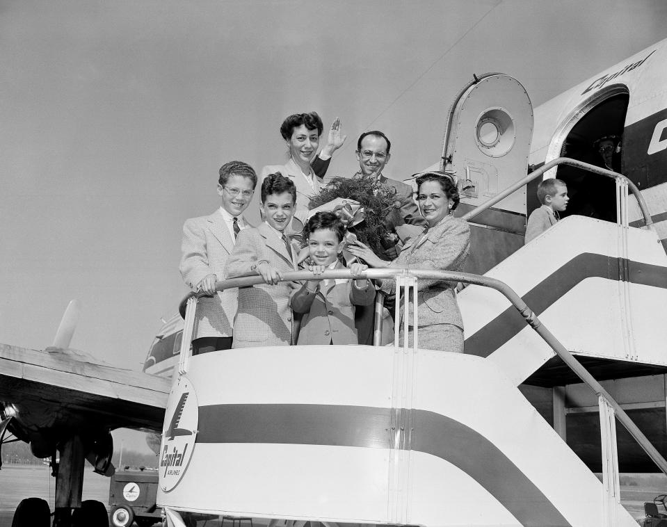 Dr. Jonas Salk on a plane with his family after the polio vaccine is determined to be 90% effective