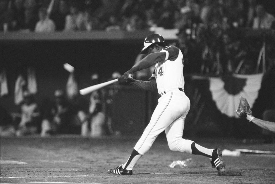 FILE - Atlanta Braves' Hank Aaron hits his 715th career home run in Atlanta Stadium, April 8, 1974, to break the all-time record set by the late Babe Ruth. The ball is a blur as it leaves the bat. Aaron made history with one swing of his bat. A year later and on the other side of Georgia, Lee Elder made history with one swing of his driver. Their deaths in 2021 were mourned beyond the sports world and were reminders of the hate, hardships and obstacles they endured with dignity on their way to breaking records and barriers. (AP Photo/Joe Holloway, Jr., File)