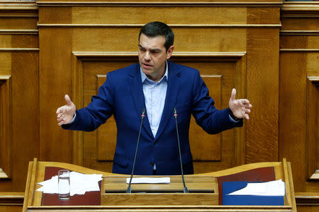 Greek Prime Minister Alexis Tsipras addresses lawmakers during a parliamentary session before a vote following a motion of no confidence by the main opposition in dispute over a deal on neighbouring Macedonia's name, in Athens, Greece June 16, 2018. REUTERS/Costas Baltas