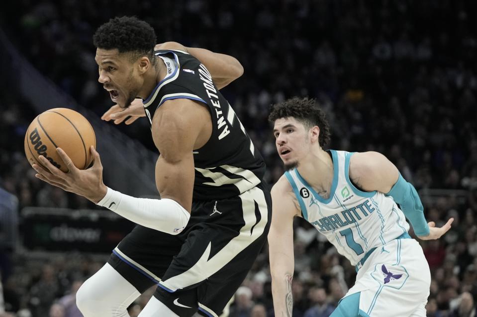 Milwaukee Bucks' Giannis Antetokounmpo gets past Charlotte Hornets' LaMelo Ball during the second half of an NBA basketball game Tuesday, Jan. 31, 2023, in Milwaukee. The Bucks won 124-115. (AP Photo/Morry Gash)