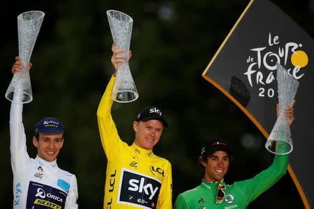 Cycling - The 104th Tour de France cycling race - The 103-km Stage 21 from Montgeron to Paris Champs-Elysees, France - July 23, 2017 - Orica-Scott rider and white jersey Simon Yates of Britain, Team Sky rider and yellow jersey Chris Froome of Britain and Team Sunweb rider and green jersey Michael Matthews of Australia on the podium. REUTERS/Christian Hartmann