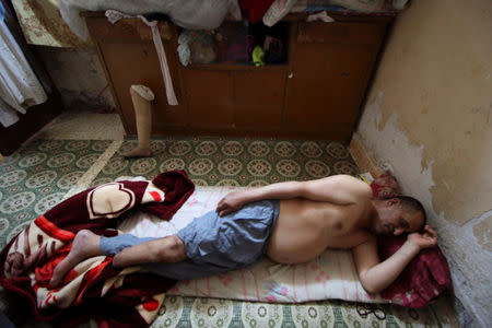 Rafed, a man disabled by a landmine explosion, sleeps at his house in the village of Bitr, which in Arabic means "amputation", in Al-Tanouma district, east of Basra, Iraq March 26, 2018. REUTERS/Essam Al-Sudani