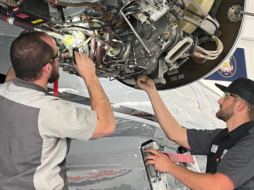 Duncan Aviation mechanics work on a HTF7000 engine.