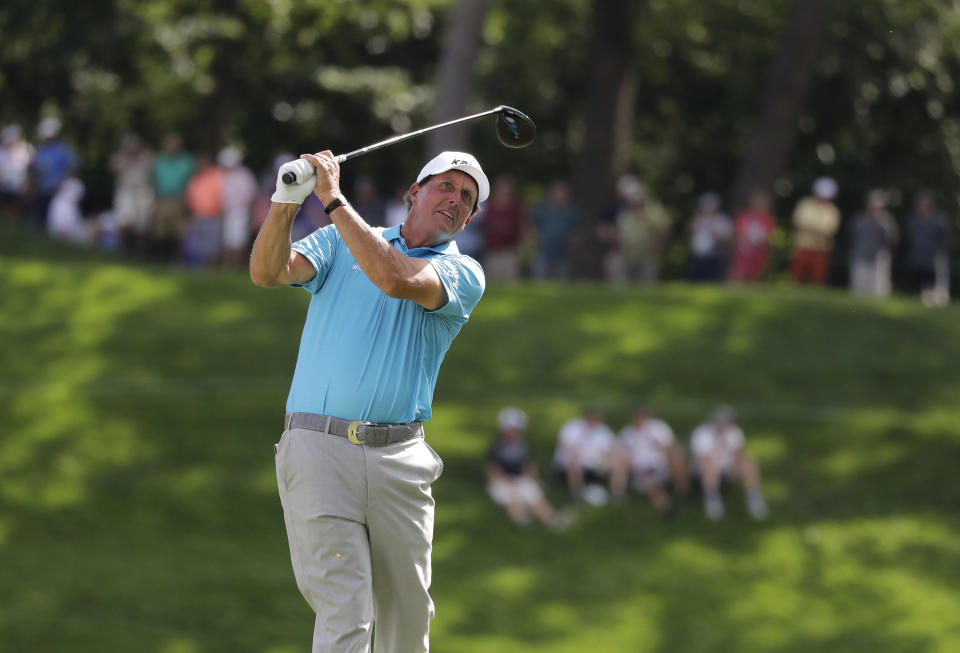 Phil Mickelson watches his tee shot on the 18th hole during the second round of the BMW Championship golf tournament at Medinah Country Club, Friday, Aug. 16, 2019, in Medinah, Ill. (AP Photo/Nam Y. Huh)