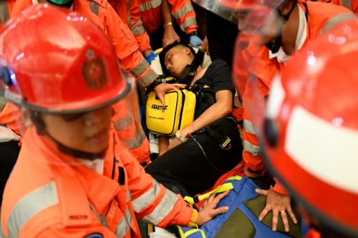 Two men were beaten by protesters at Hong Kong airport on Tuesday, one accused of being a Chinese spy and the other of being an undercover police officer