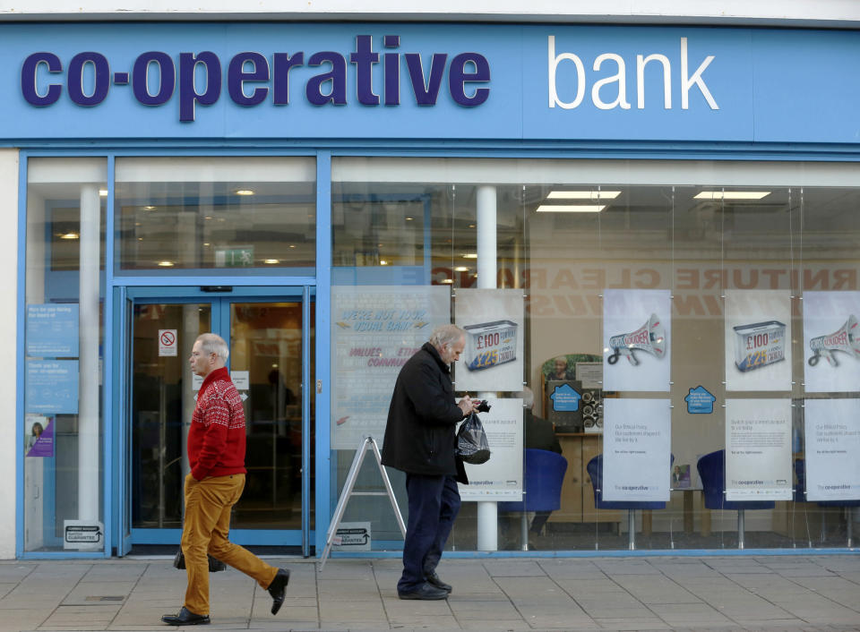 Pedestrians pass a branch of The Co-operative Bank in Brighton southern England December 16, 2014.  The Bank of England gave Britain's state-backed lenders a narrow pass in its debut annual stress tests on Tuesday, but warned that next year banks would face tougher checks of their capital strength and international exposure. Lloyds and rival Royal Bank of Scotland scraped through a doomsday scenario of plummeting house prices and soaring unemployment after both took pre-emptive measures to boost their defences against potential losses. The Co-operative Bank, which nearly collapsed last year before being bailed out by bondholders, was the only bank to fail the test, which was tougher on lenders with high exposures to British mortgages, such as Lloyds and Nationwide.   REUTERS/Luke MacGregor  (BRITAIN - Tags: BUSINESS)