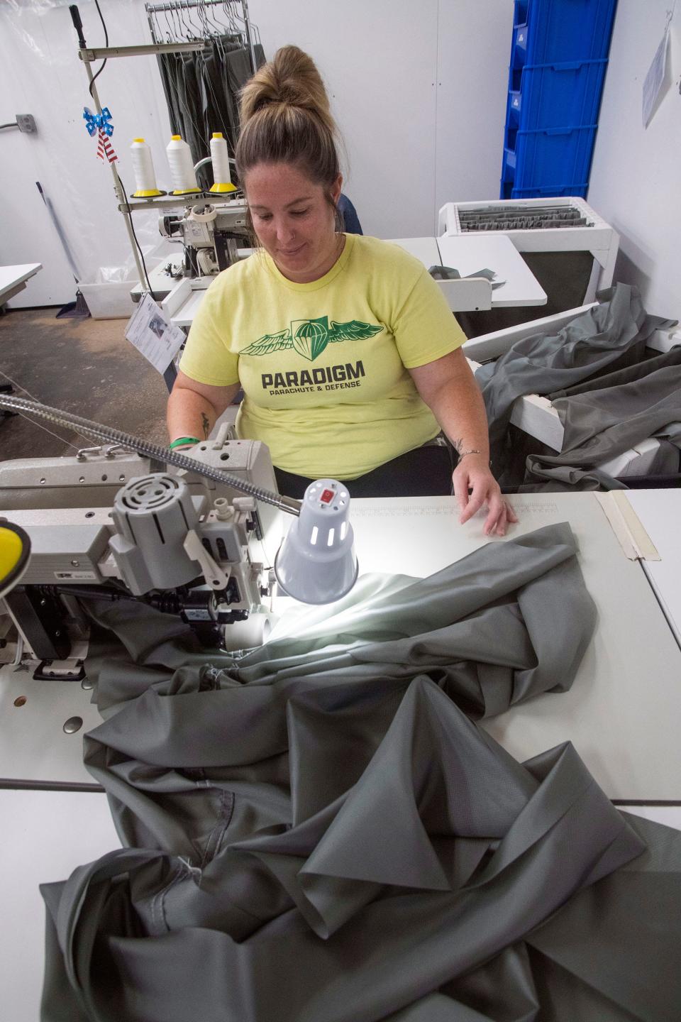 Paradigm Parachute and Defense employee April Moore sews a parachute section for a government contract at the company's facility in Escambia County on Nov. 7.