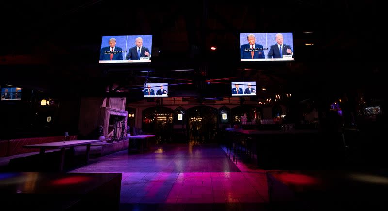 Television screens broadcast the second 2020 presidential campaign debate between Democratic presidential nominee Joe Biden and U.S. President Donald Trump at The Abbey Bar during the outbreak of the coronavirus disease (COVID-19), in West Hollywood