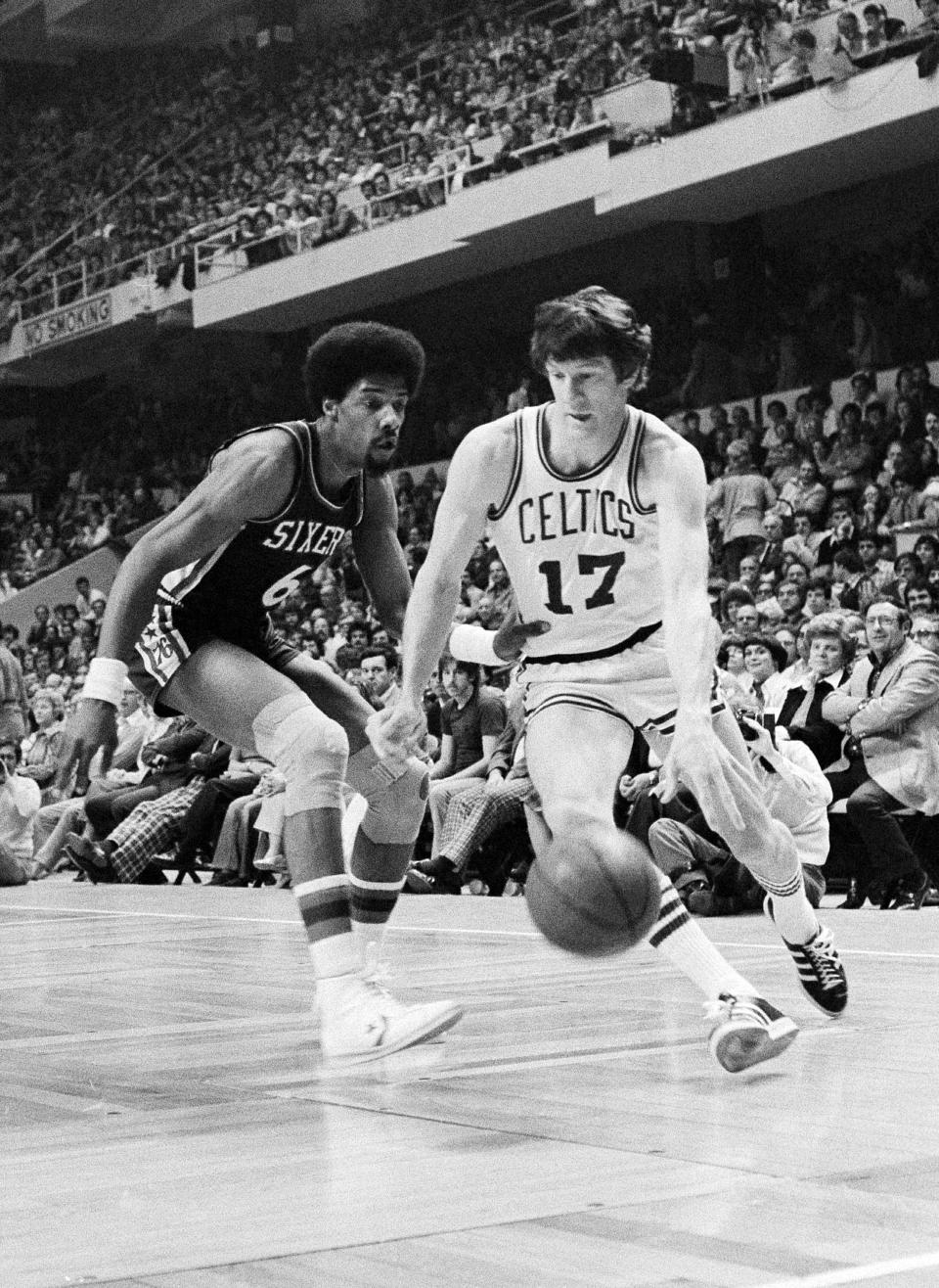 FILE - In this April 29, 1977 file photo, Boston Celtics' John Havlicek (17) moves the ball past Philadelphia 76ers' Julius Erving during an NBA basketball game in Boston. The Boston Celtics say Hall of Famer John Havlicek, whose steal of Hal Green’s inbounds pass in the final seconds of the 1965 Eastern Conference finals against the Philadelphia 76ers remains one of the most famous plays in NBA history, has died. The team says Havlicek died Thursday, April 25, 2019 at age 79.