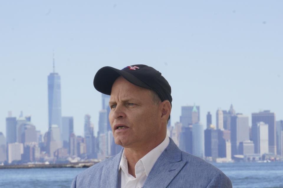 Eddie Bracken listens during an interview at the Staten Island September 11th Memorial, in view of lower Manhattan, Friday Sept. 2, 2022, in New York. Bracken, a carpenter whose sister Lucy Fishman was killed in the Sept. 11 attacks on the World Trade Center, is awaiting the trial of the attack's self-professed architect Khalid Sheik Mohammed and his co-defendants at Guantanamo. (AP Photo/Bebeto Matthews)