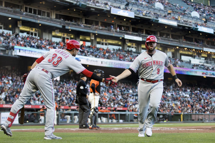 Cincinnati Reds' Mike Moustakas (9) celebrates with Aramis Garcia (33) after scoring against the San Francisco Giants during the second inning of a baseball game in San Francisco, Friday, June 24, 2022. (AP Photo/John Hefti)