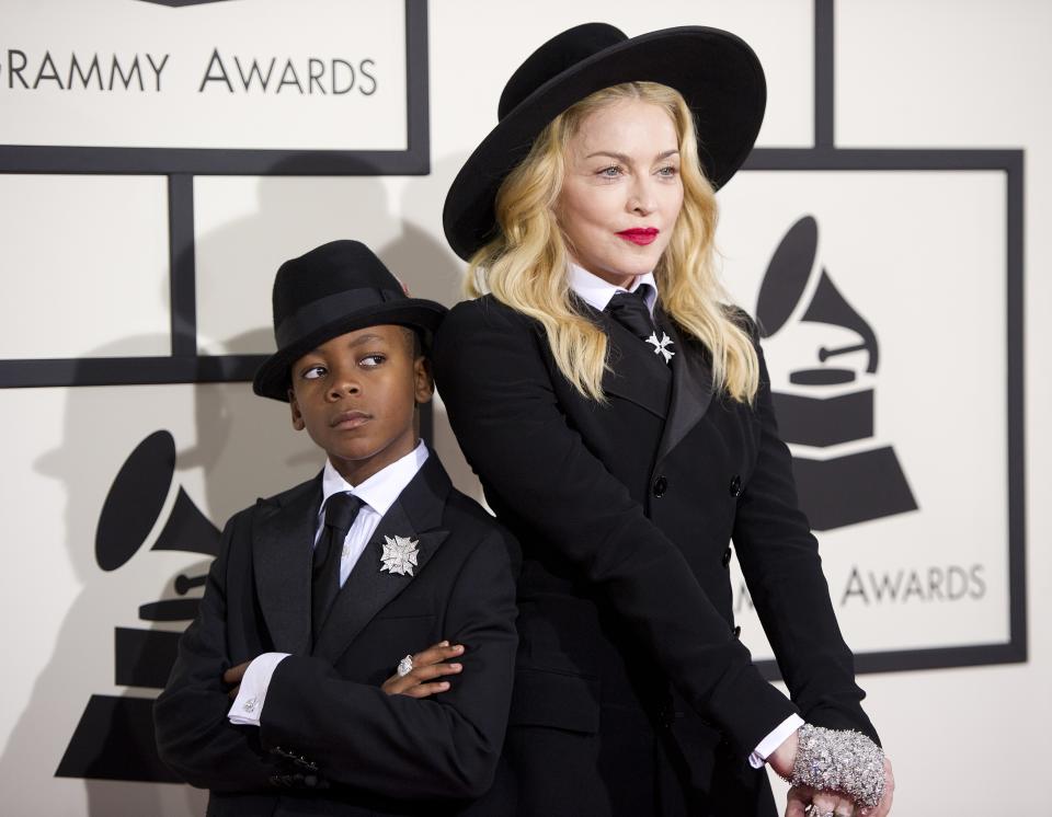 Madonna and her eight-year-old son David Banda pose on the red carpet for the 56th Grammy Awards at the Staples Center. (Credit: ROBYN BECK/AFP/Getty Images)